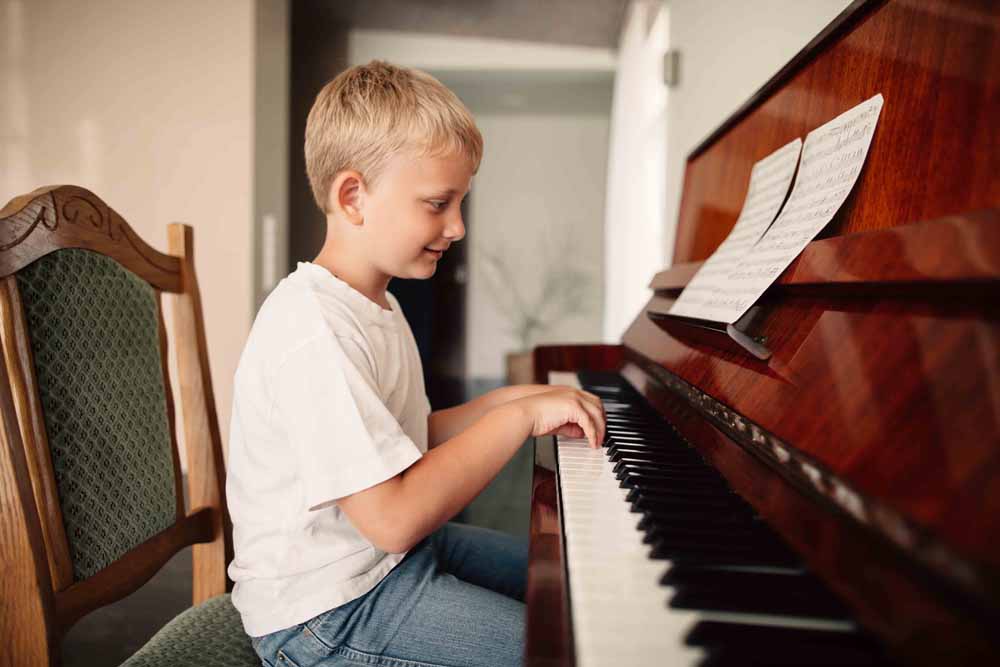 a boy playing a piano