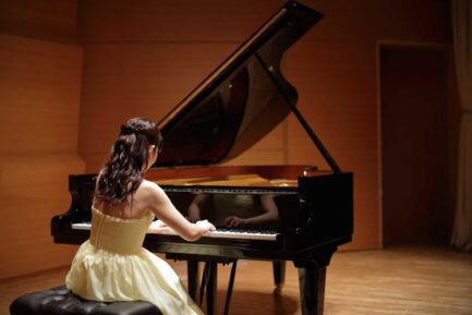 a woman playing a piano