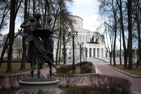 a statue of three women in a park academy